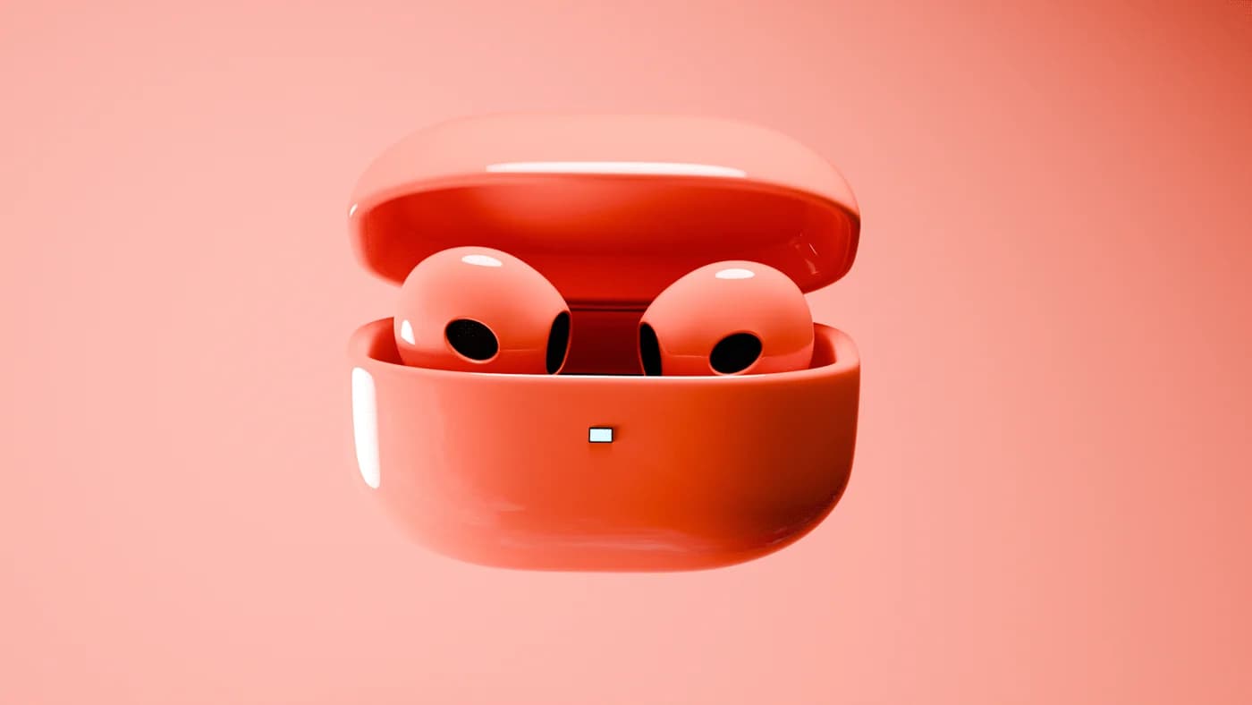 Coral earbuds in an open case on a warm red gradient