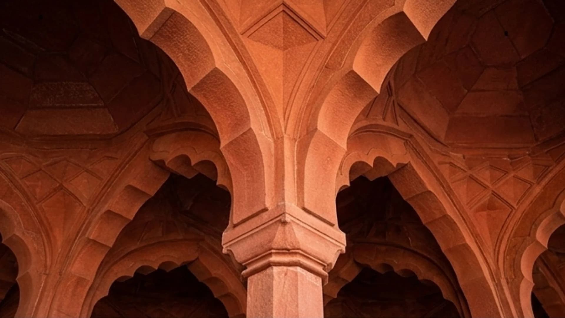 Carved red sandstone arches and vaulting of a digital palace interior