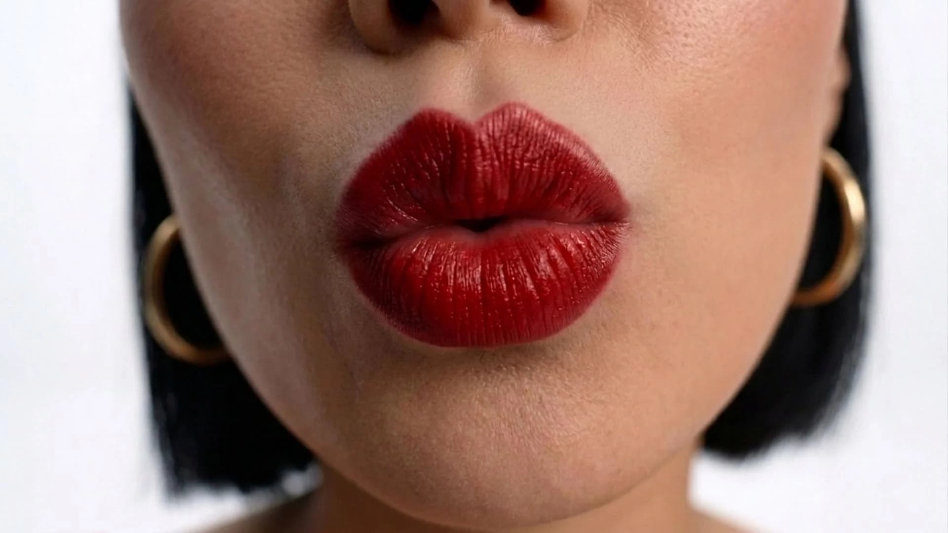 Close crop of a model's red lips wearing GURU lipstick