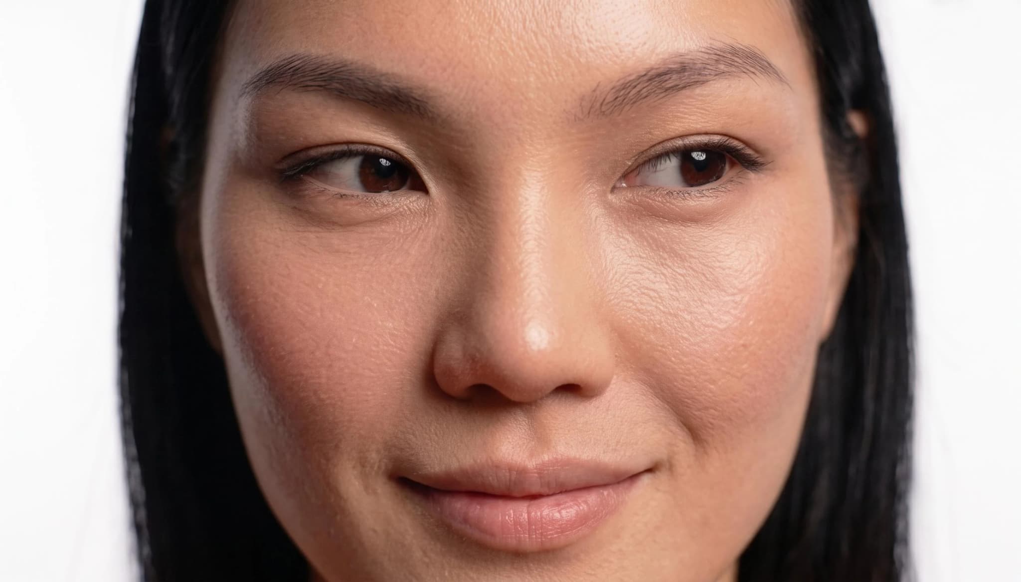 Close crop of the AI model's face showing photoreal skin detail